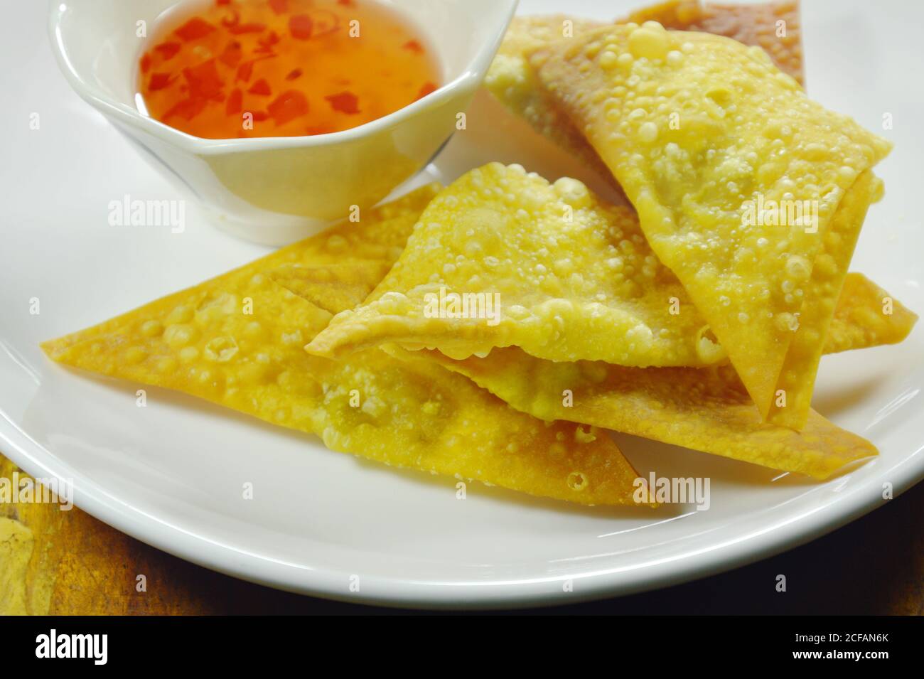 crispy fried dumpling paste dipping sweet chili sauce on plate Stock