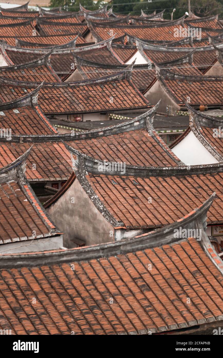 Aerial view of aged oriental buildings with curved roofs covered with tile and placed in rows in Daimei Village Stock Photo