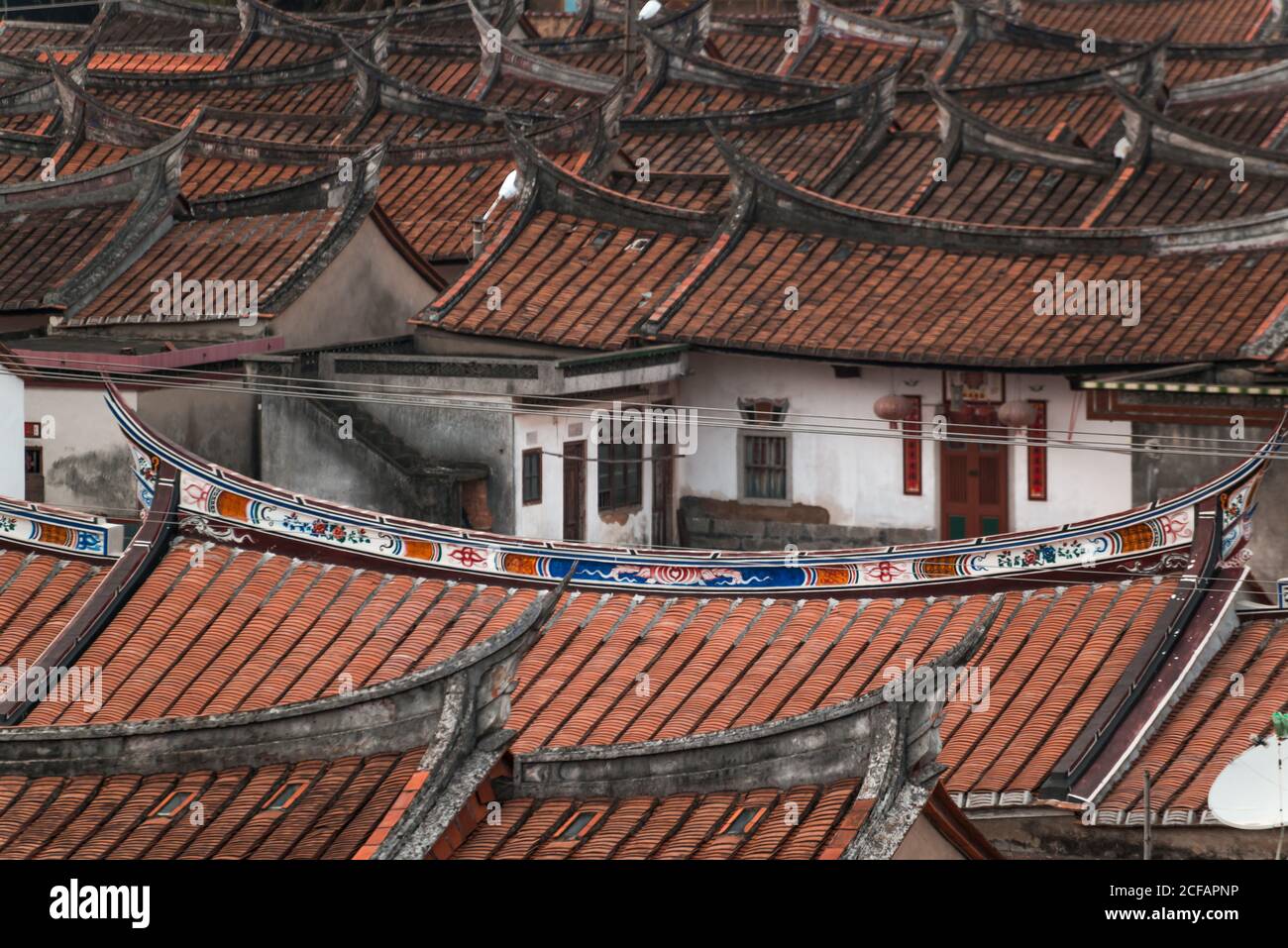 Aerial view of aged oriental buildings with curved roofs covered with tile and placed in rows in Daimei Village Stock Photo