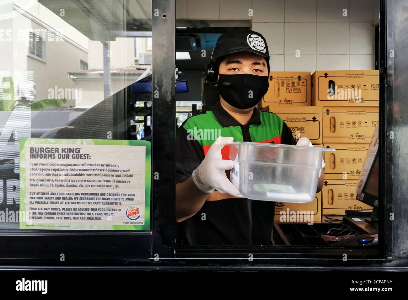 Bangkok, Thailand - September 4, 2020 : Burger King fast food cashier service wearing face mask to protect coronavirus pandemic or covid-19 outbreak g Stock Photo