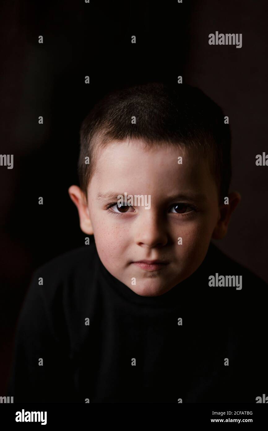 Portrait of thoughtful little boy looking at camera during taking ...