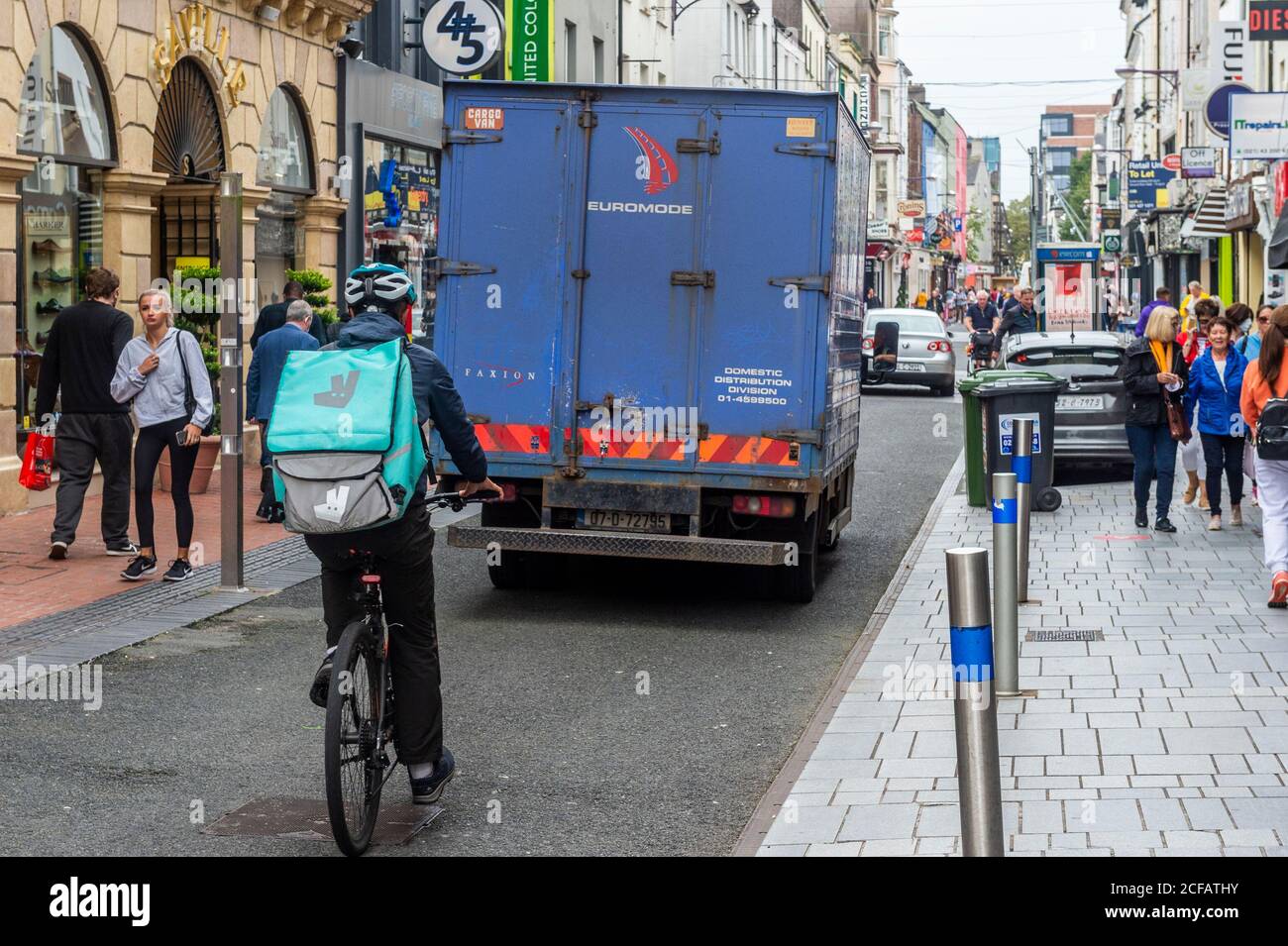 Cork, Ireland. 4th Sep, 2020. A Deliveroo food delivery rider cycles down Oliver Plunkett Street in Cork City today. A Deliveroo employee, 28 year old Thiago Cortes, a Brazillian national, was killed in Dublin on Monday night last after making a delivery in the capital. Credit: AG News/Alamy Live News Stock Photo