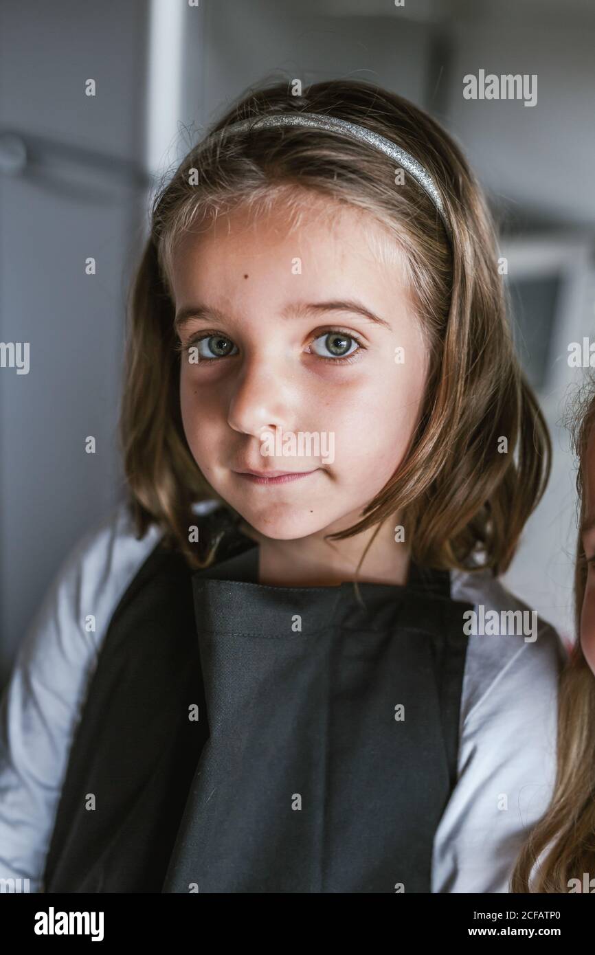 Portrait of cute young girl looking at camera indoors Stock Photo - Alamy