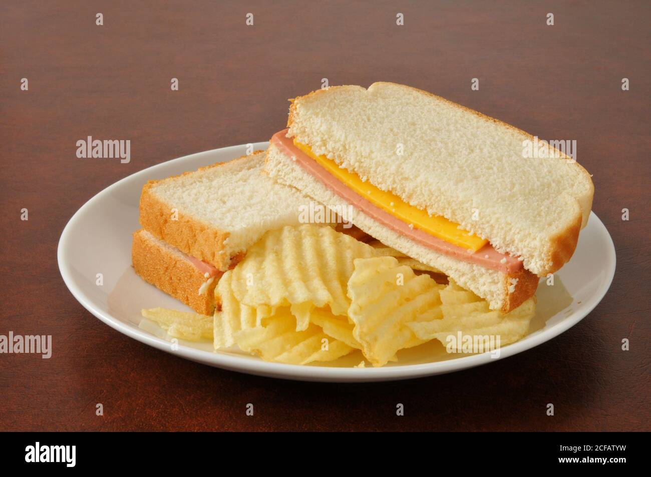 A bologna and cheese sandwich with potato chips Stock Photo Alamy