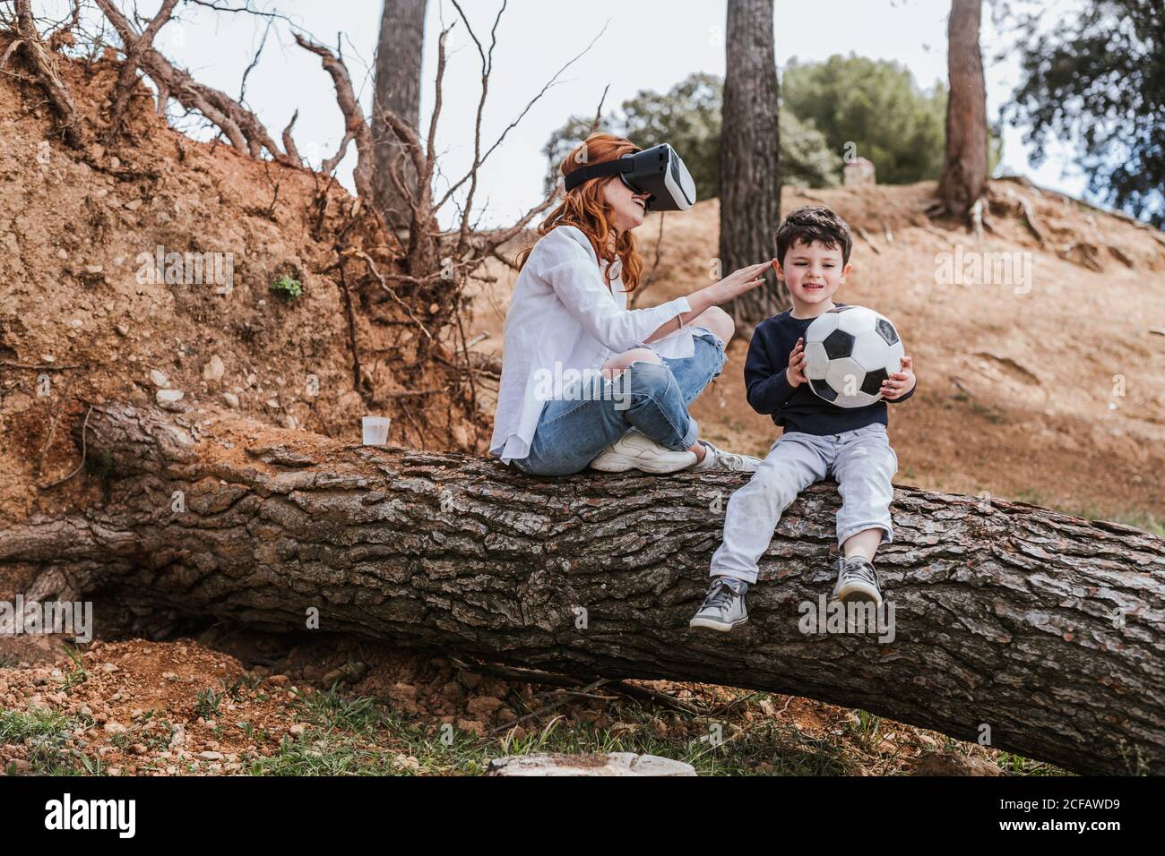 boy looking at mother in VR headset Stock Photo