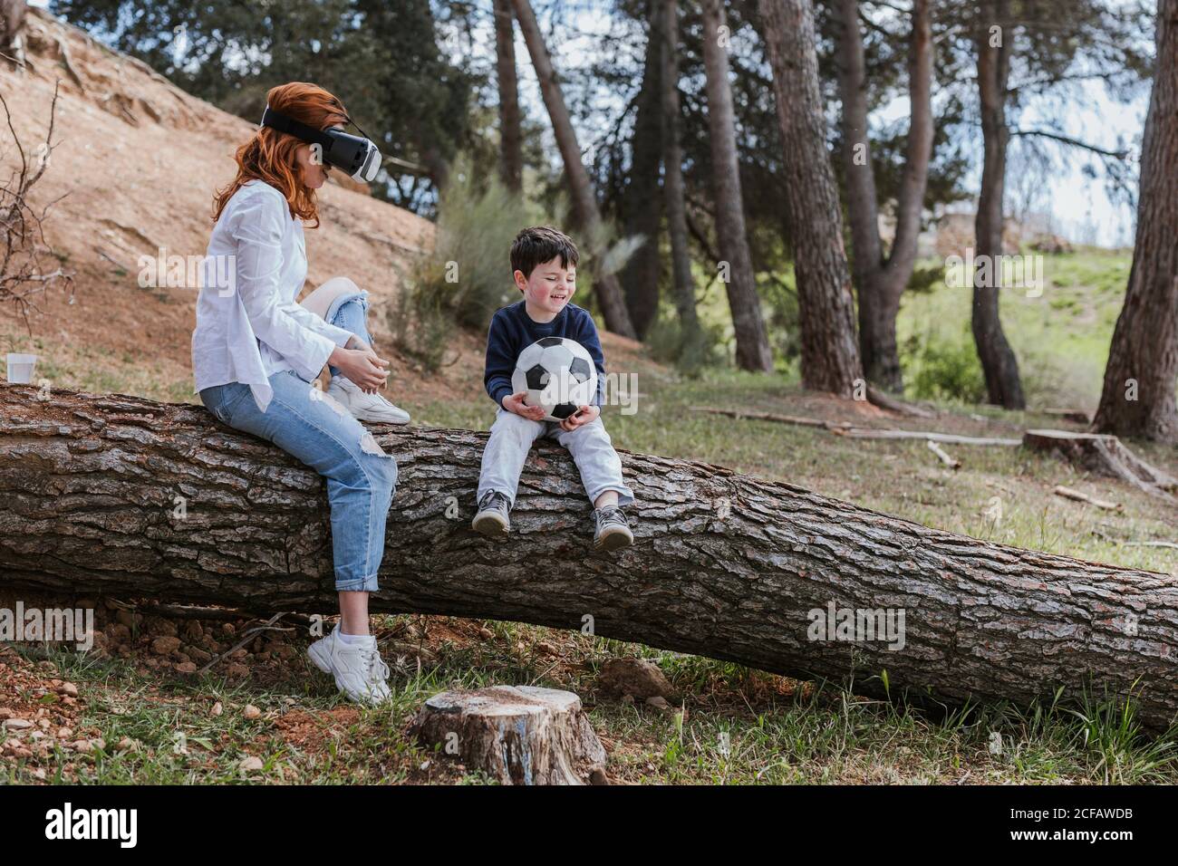 boy looking at mother in VR headset Stock Photo