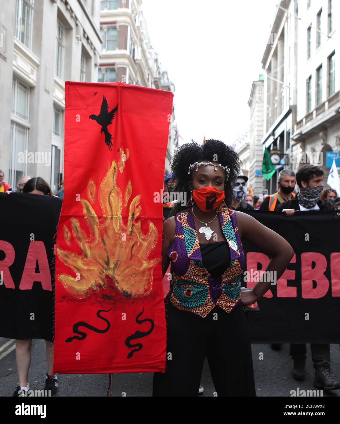 Protester, Marvina Newton, leads demonstrators through the City of London, during an Extinction Rebellion protest. Stock Photo