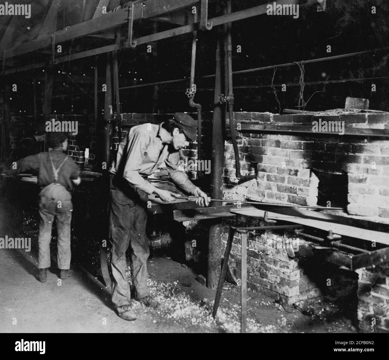 Putting Bottles into the Annealing Oven. An Indianapolis Glass Works, 1