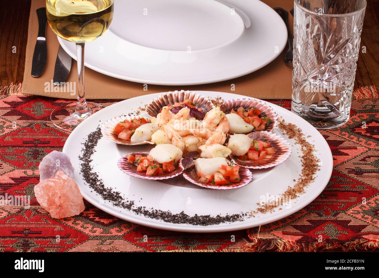 Mixed seafood platter (Scallops with tomato salsa and shrimp) served with purple and Black salt