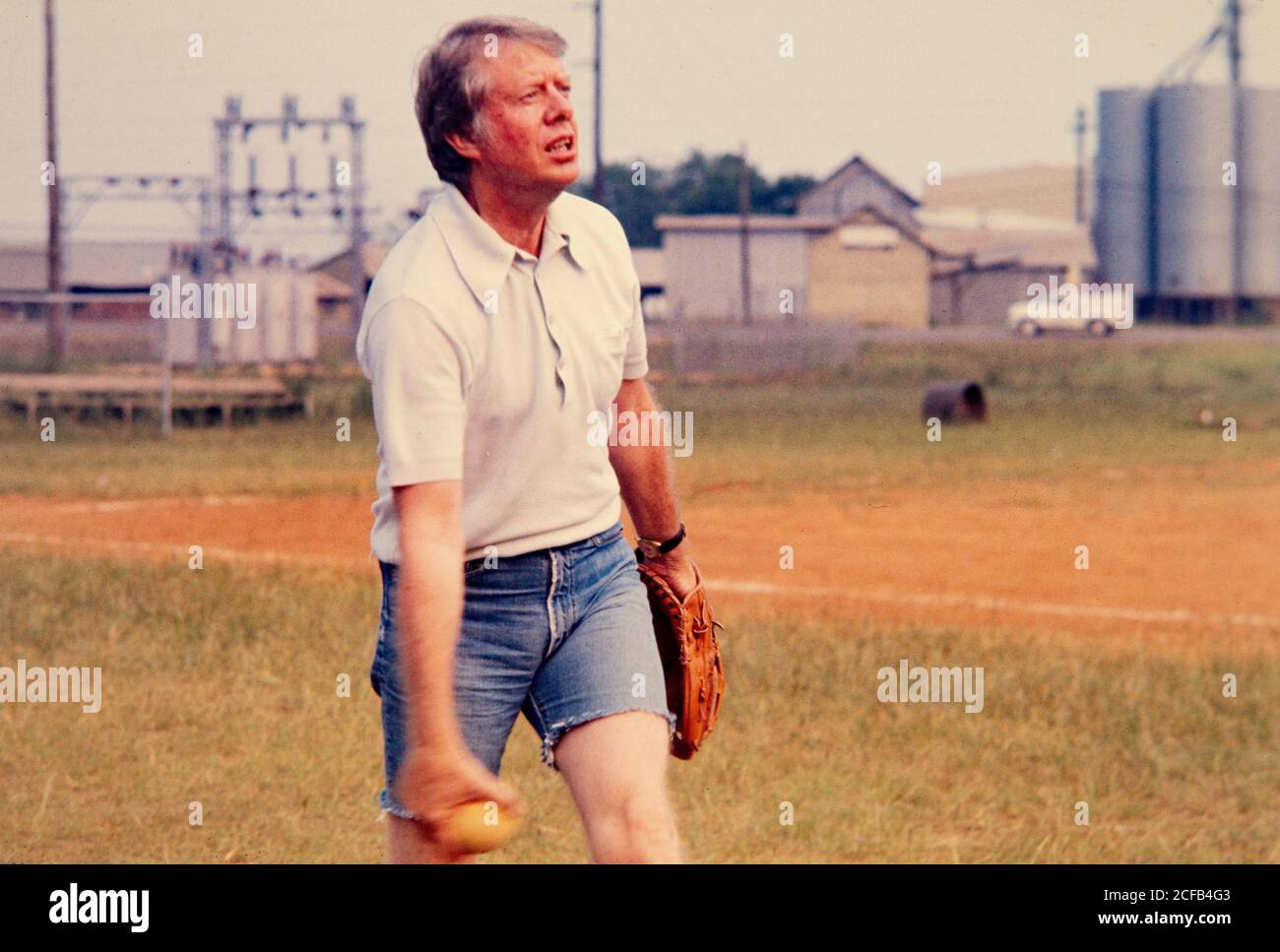 US president Jimmy Carter plays softball on the field of his high school  alma mater - the Plains, Georgia High School. Carter captained his team  made up of his staff and off