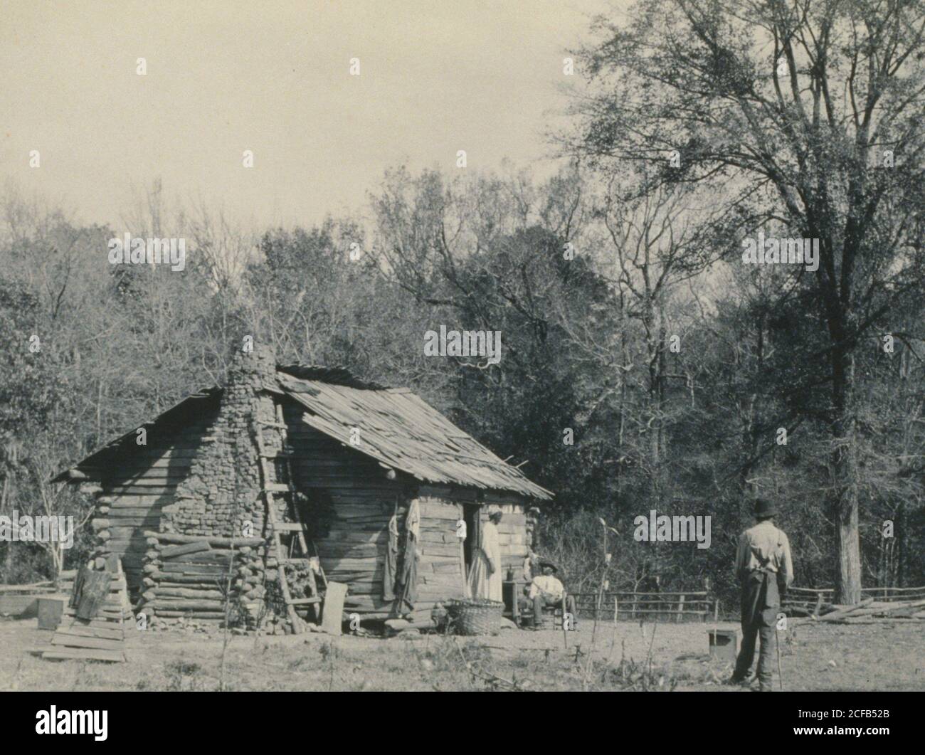 Three African Americans outside a cabin, possibly Mt. Meigs, Alabama ...