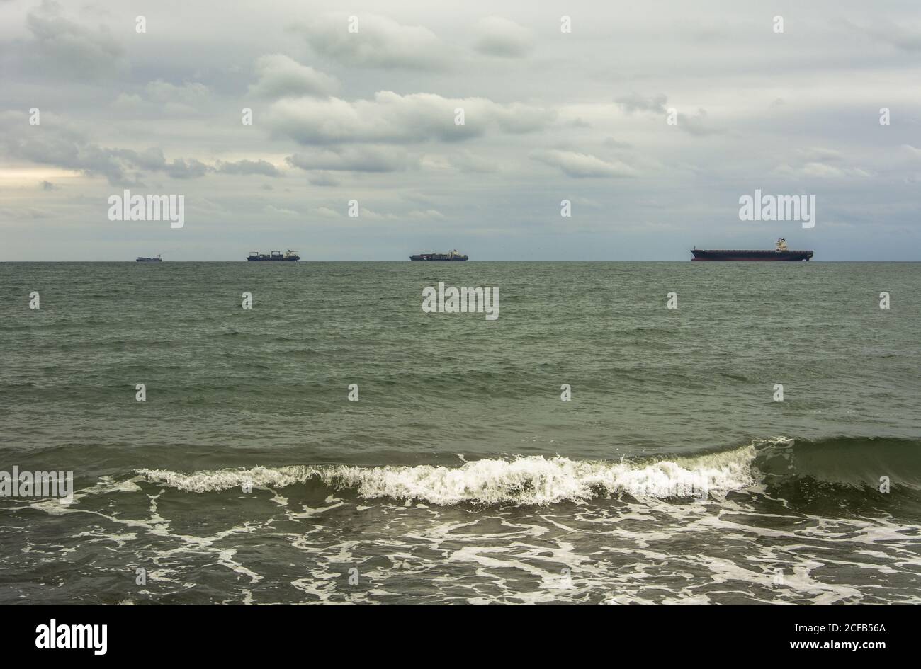 Four ships in the horizon Stock Photo - Alamy