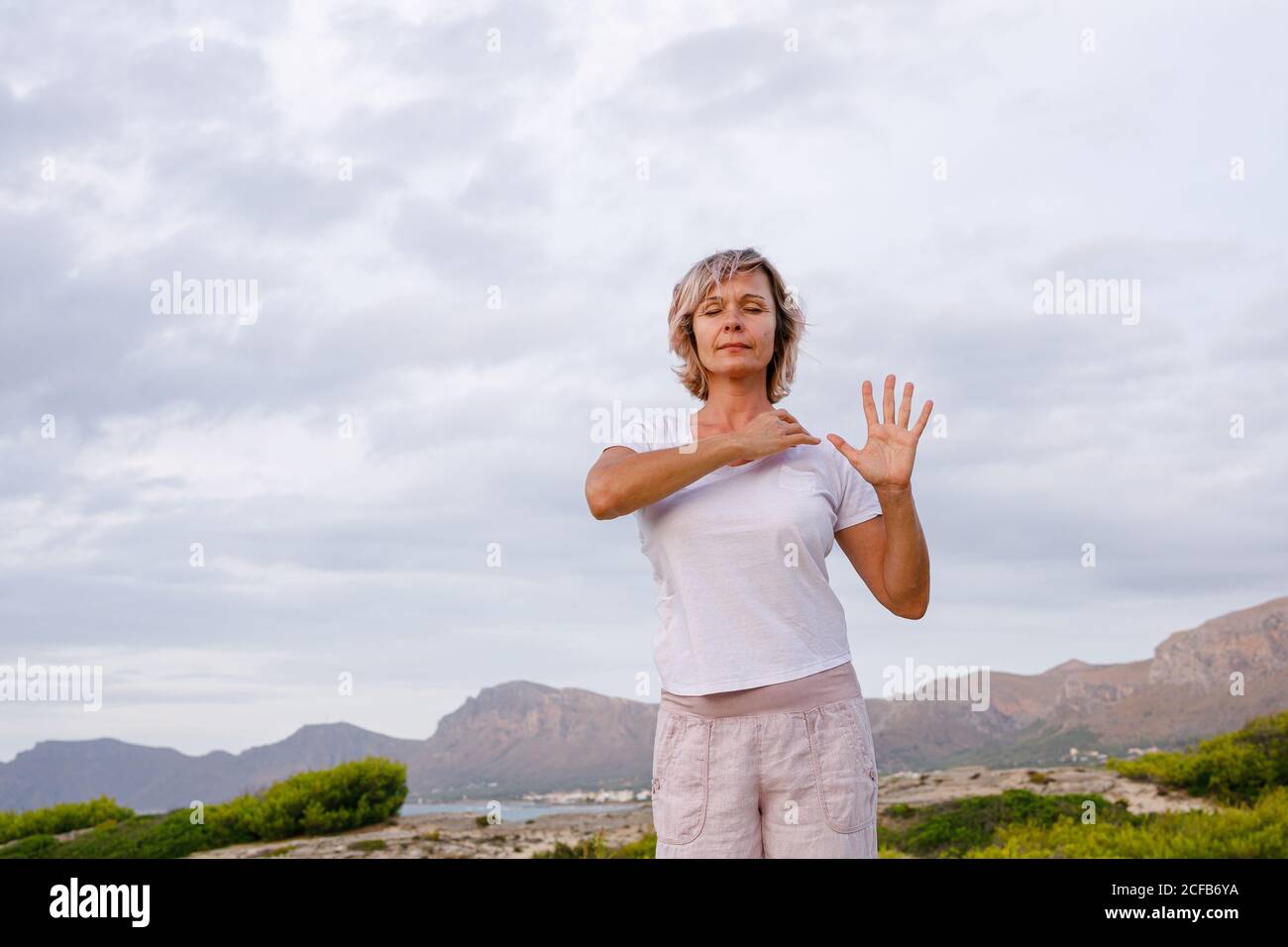 Adult Woman doing breathing exercise Stock Photo