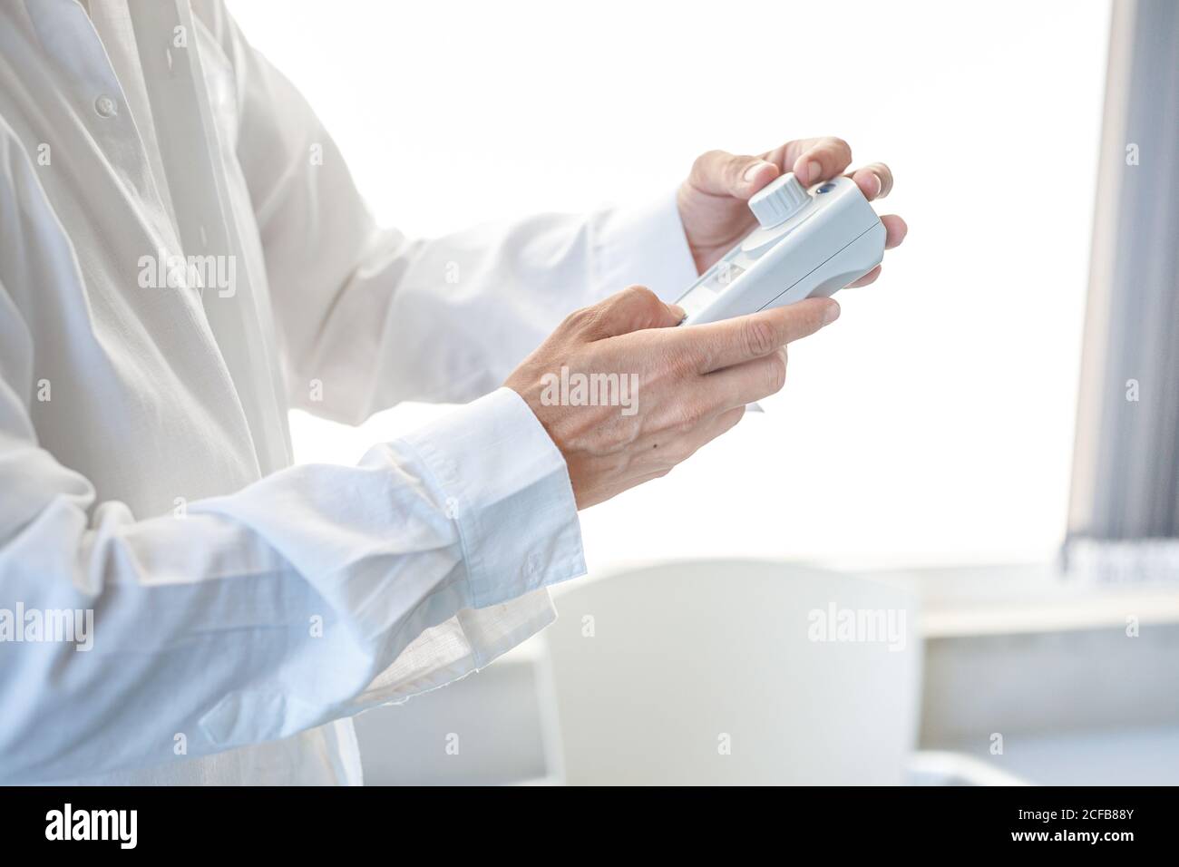 Assistant working in lab with pink liquid Stock Photo
