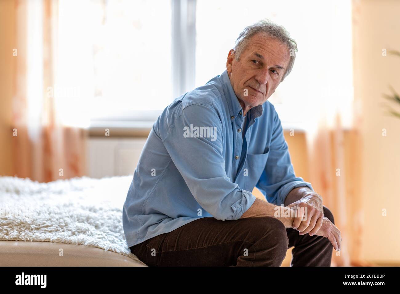 Portrait of senior man looking depressed Stock Photo
