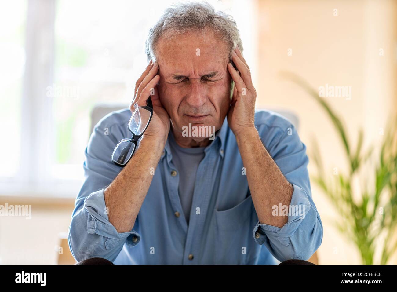 Senior man suffering from a headache Stock Photo