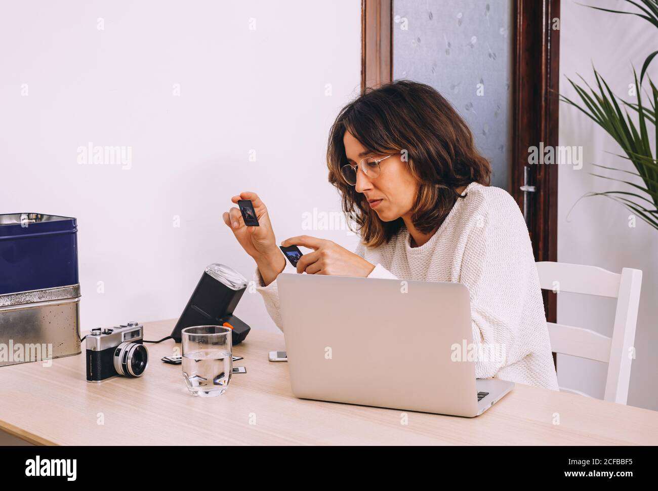 Photographer at the desk, office gadgets and object lens Stock