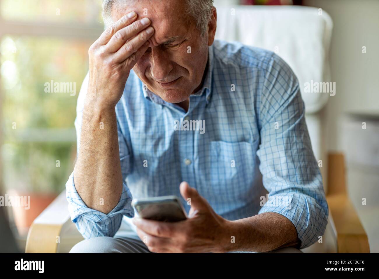 Senior man suffering from a headache Stock Photo