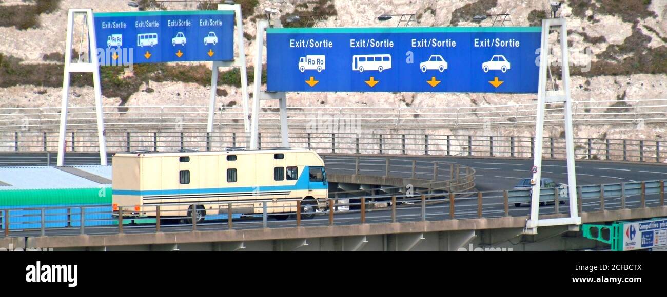 Port of Dover docks white cliffs Exit Sortie route signs horse box lorry truck arriving off of ferry boat driving on four lane flyover Kent England UK Stock Photo