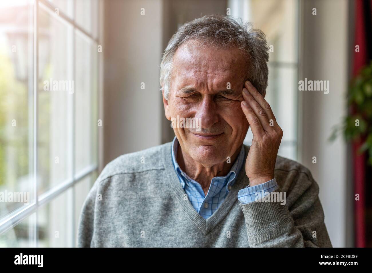 Senior man suffering from a headache Stock Photo