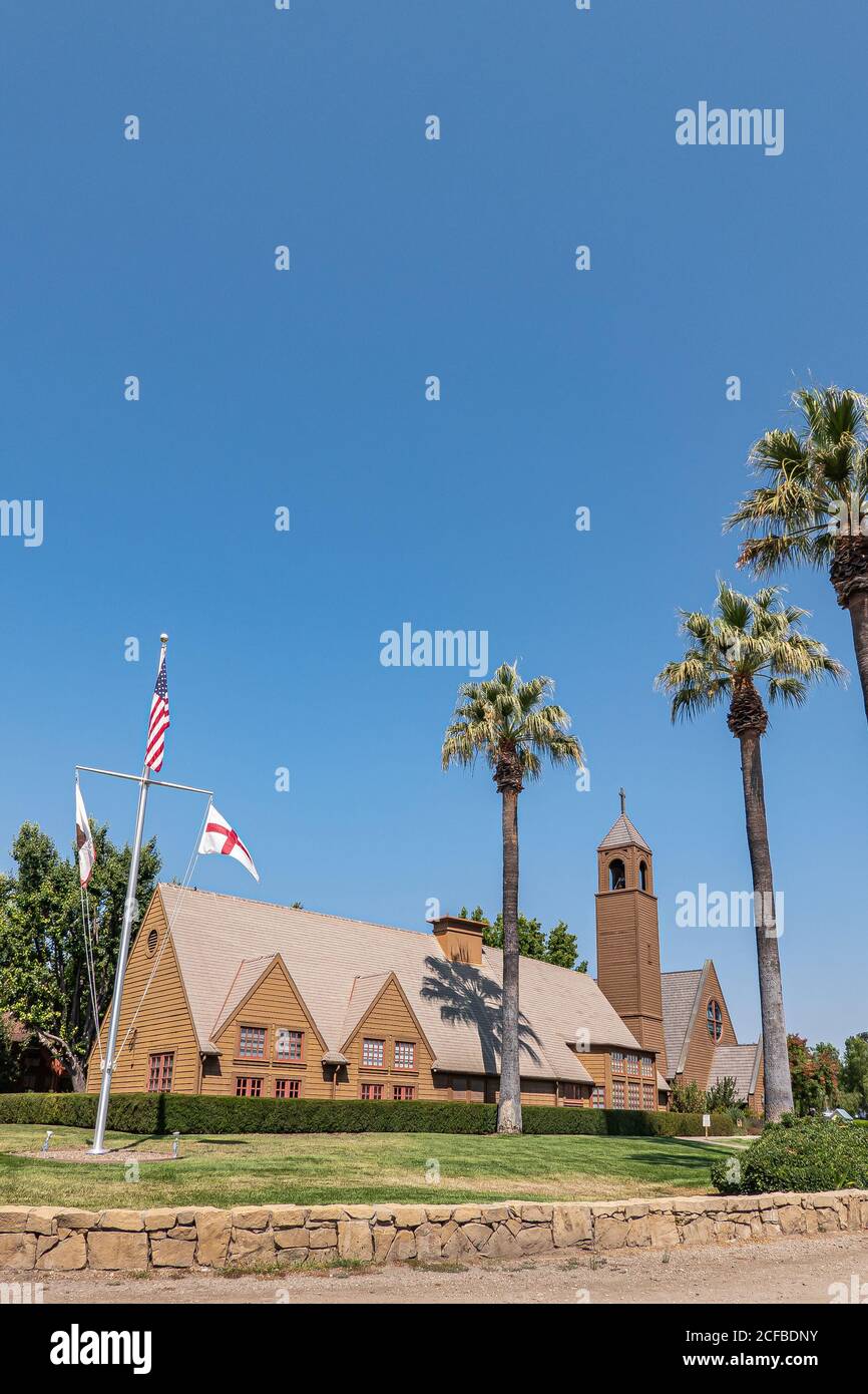 Los Olivos, California, USA - September 3, 2020: Portrait of brown wood St. Marks in the Valley Church with bell tower set in green park under blue sk Stock Photo