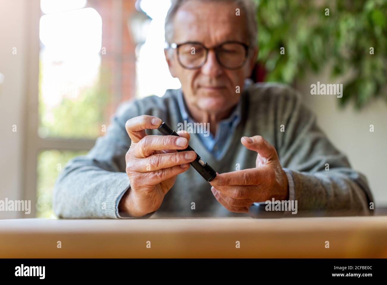 Man Using Glucometer One level house hi-res stock photography and images - Alamy
