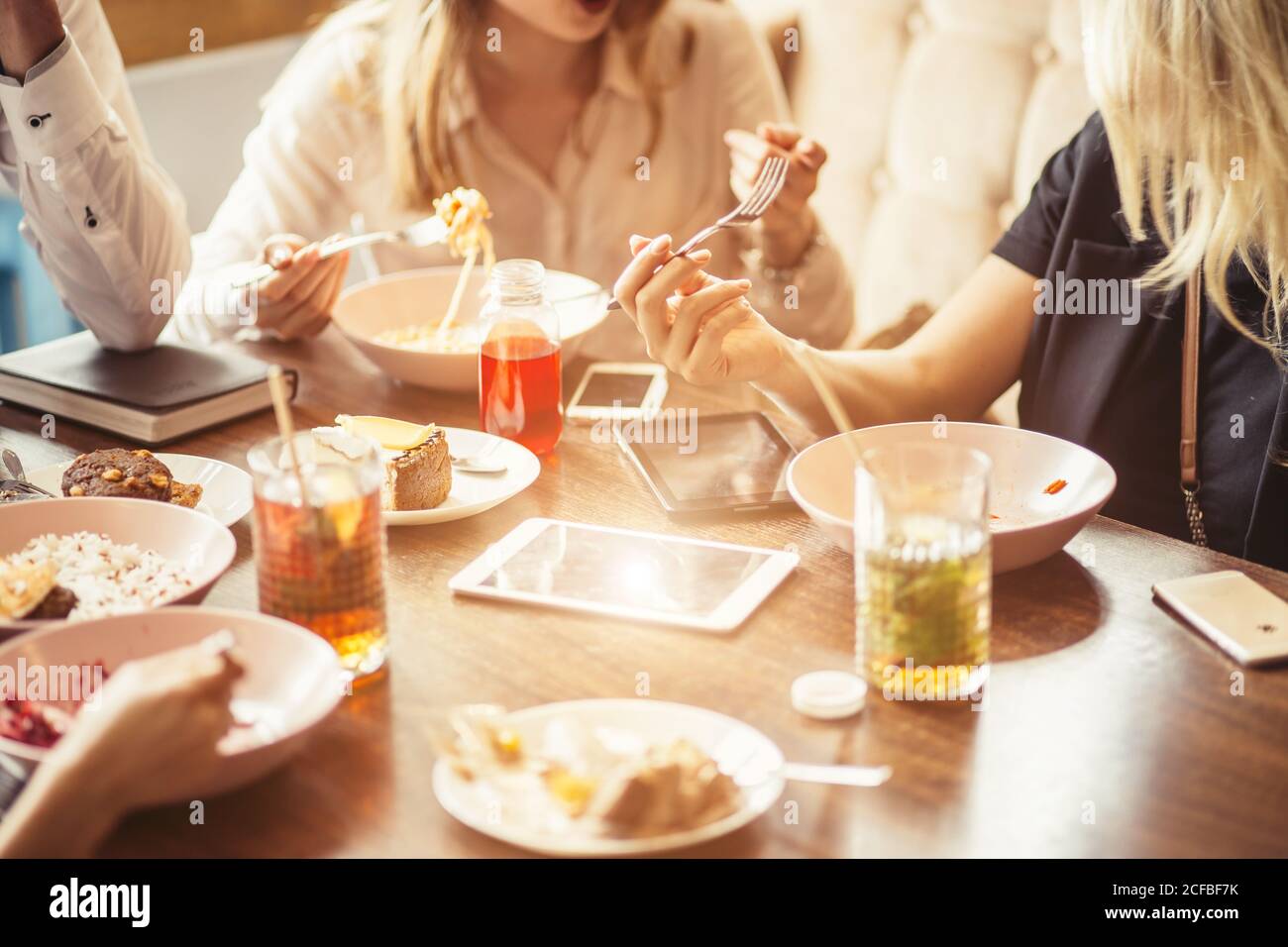 people, leisure and food concept close up friends having dinner and