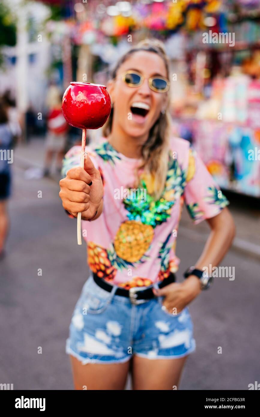 Cheerful lady having fun enjoying sweet candy apple Stock Photo Alamy