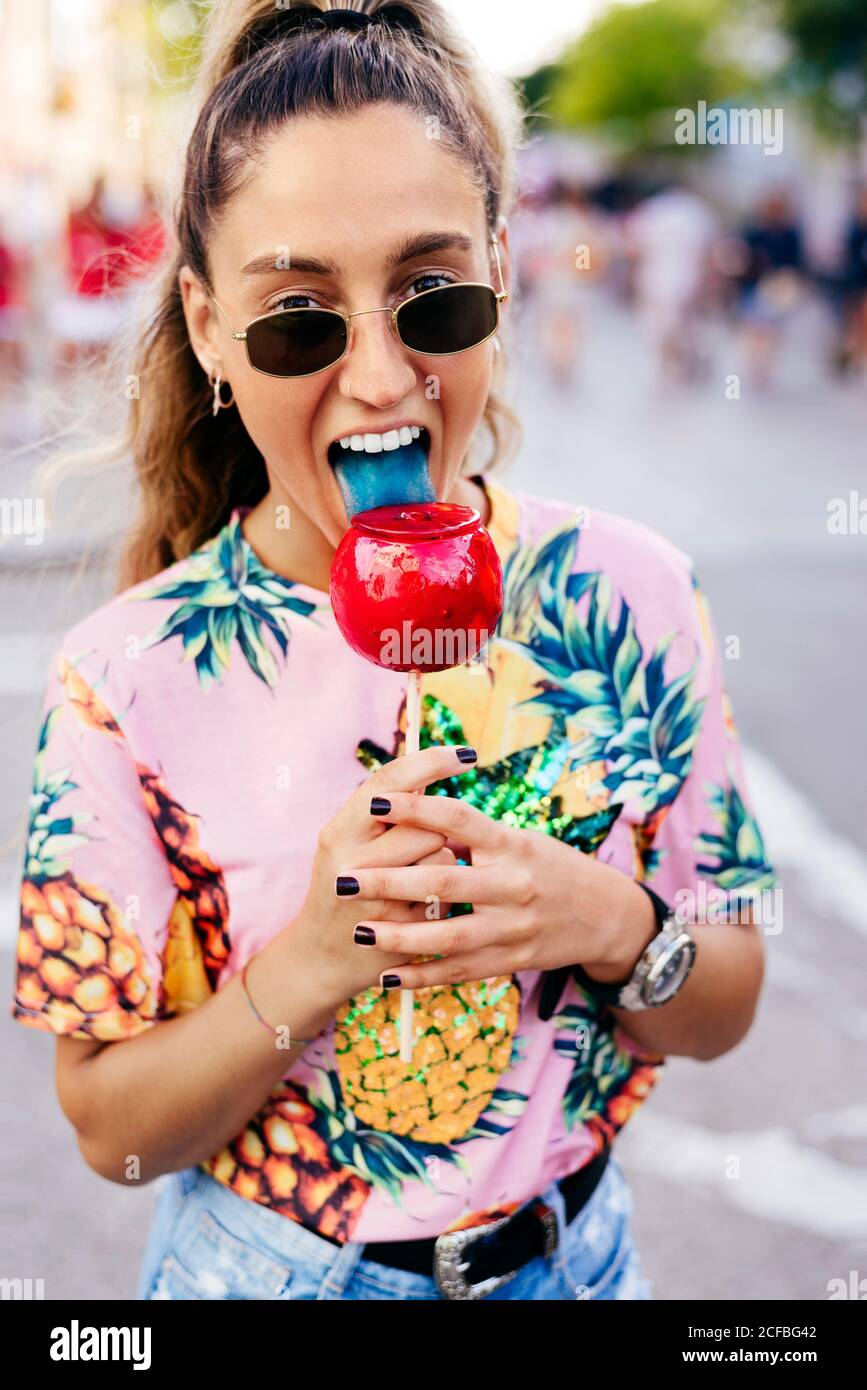 Cheerful lady having fun enjoying sweet candy apple Stock Photo Alamy
