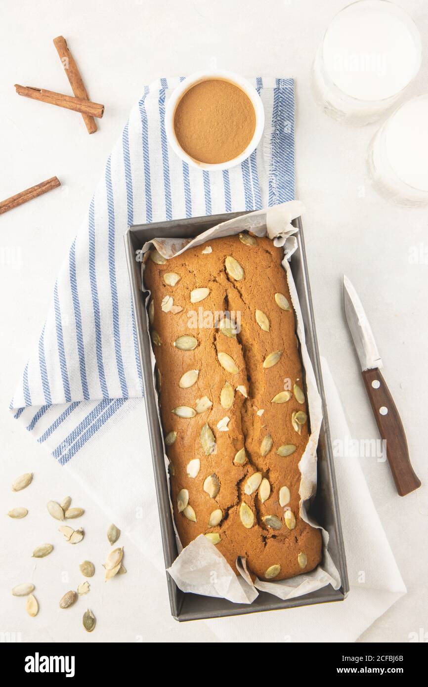 Fresh homemade pumpkin bread in pan with pumpkin puree, cinnamon