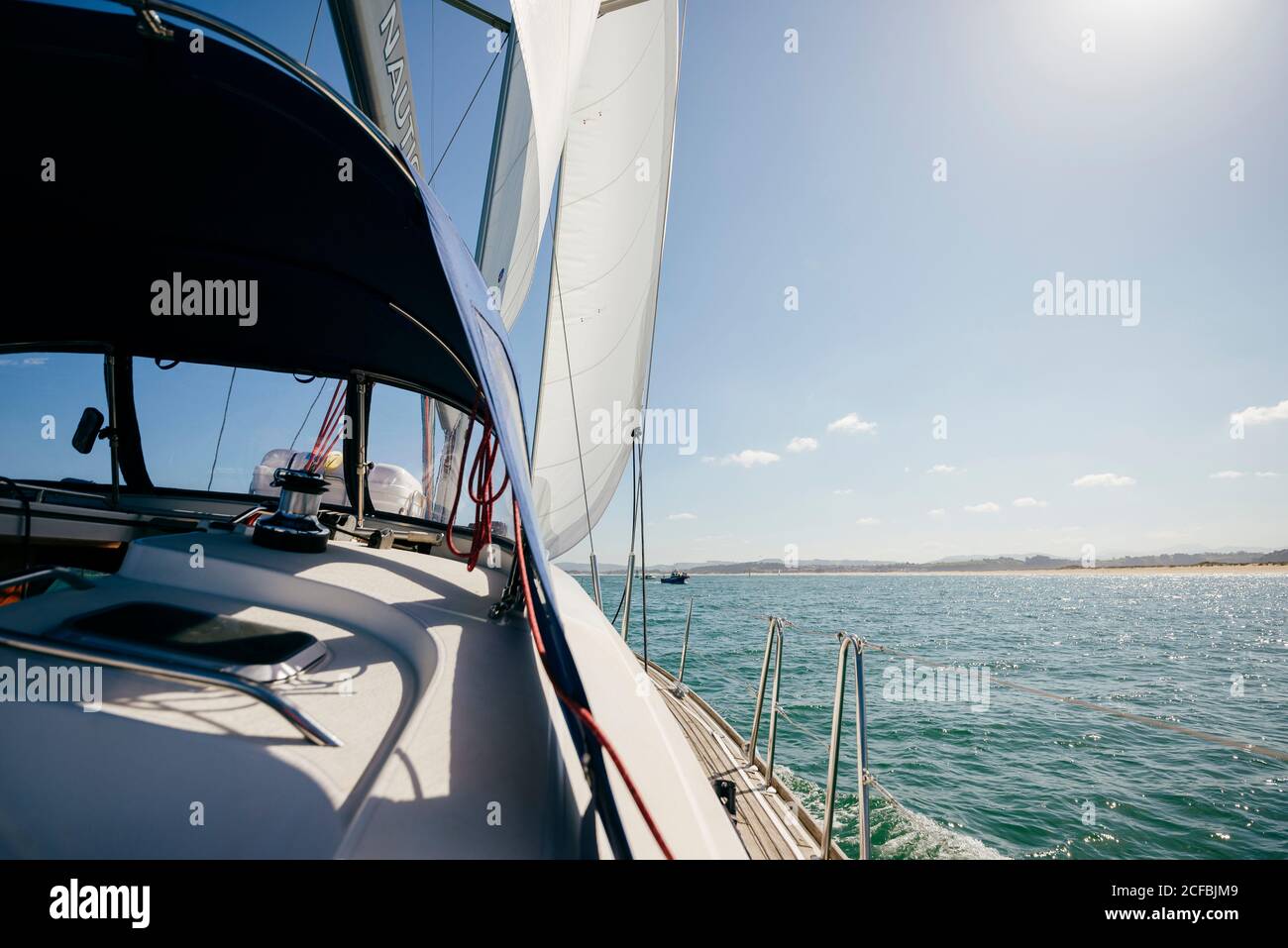 Modern motorboat floating on rippling sea water in sunny summer day with blue sky Stock Photo