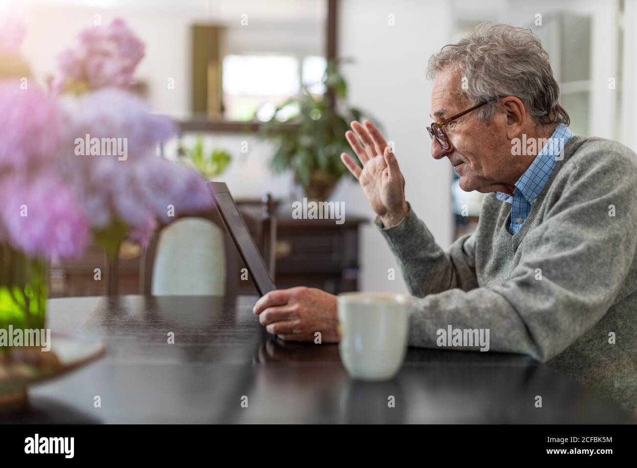 Senior man using laptop at home Stock Photo