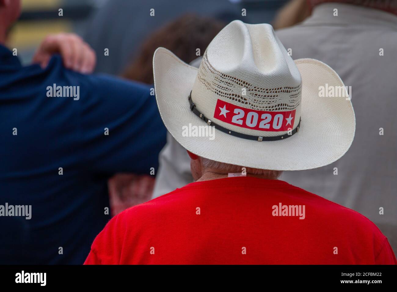 A man with a makeshift MAGA cowboy hat listens on as President Trumps  speaks about the success of the food box program Stock Photo - Alamy