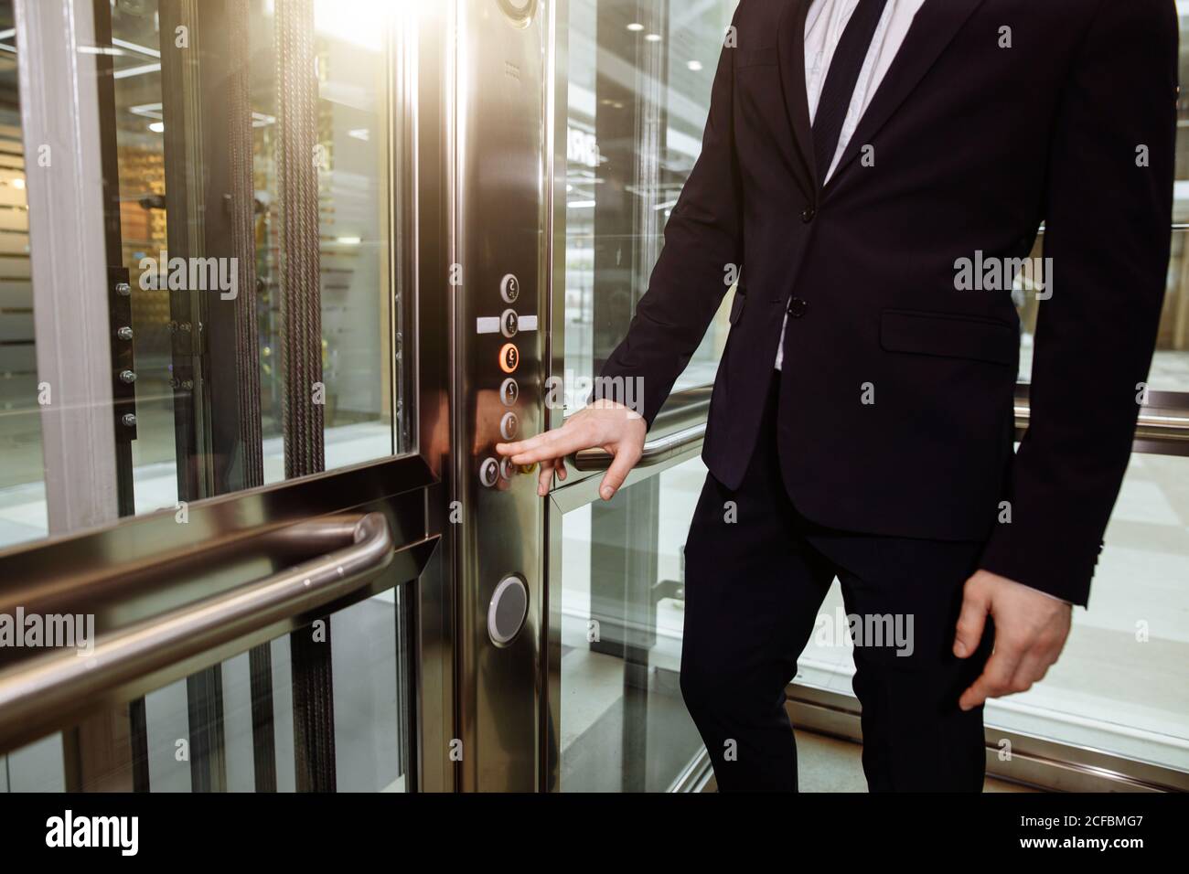 Man pressing elevator button. finger presses elevator button. businessman in lift Stock Photo