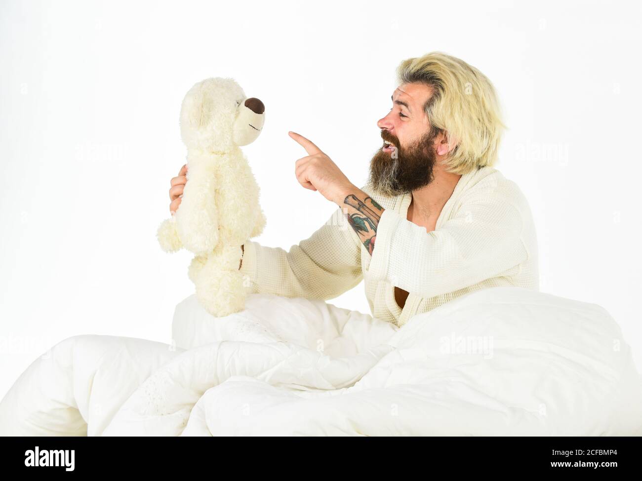 talk to you. feel childish. bearded man hipster play with bear