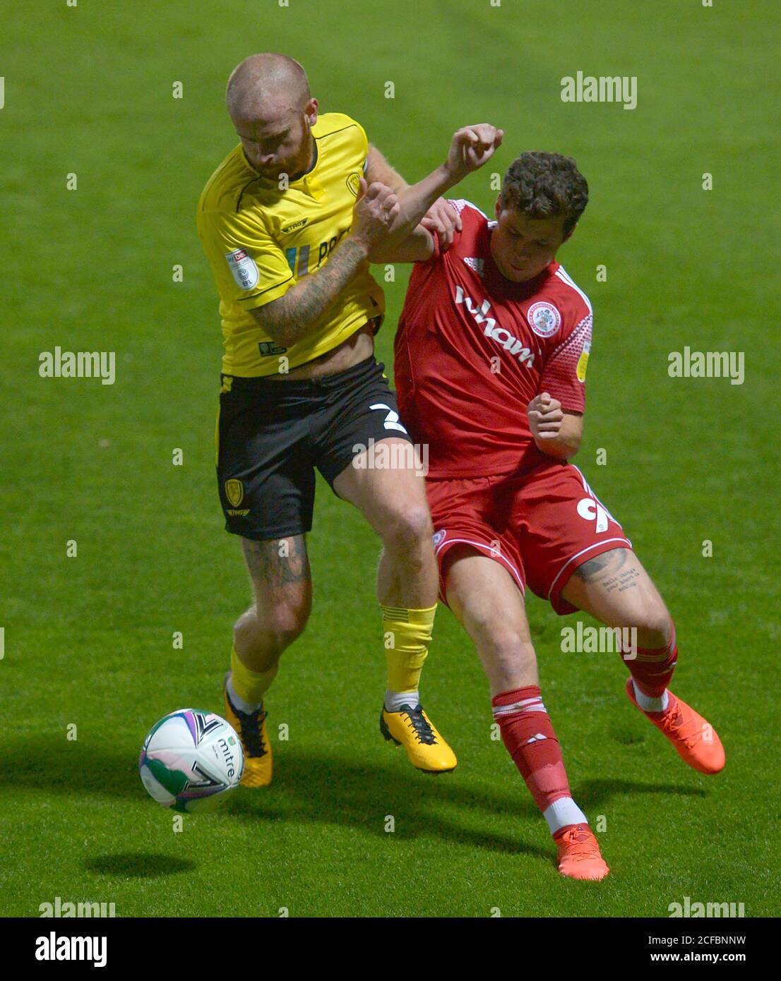 Burton Albion's John Brayford (left) and Accrington Stanley's Ryan Cassidy battle for the ball during the Carabao Cup first round match at the Pirelli Stadium, Burton upon Trent. Stock Photo