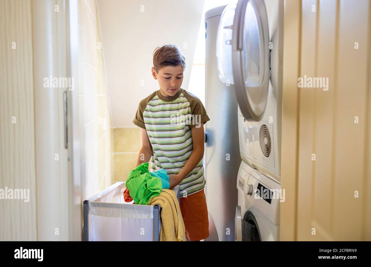 Loading washing machine at home Stock Photo