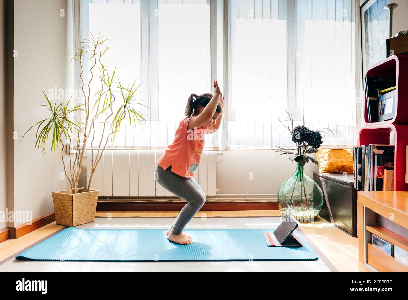 Little girl with yoga mat on white background Stock Photo - Alamy