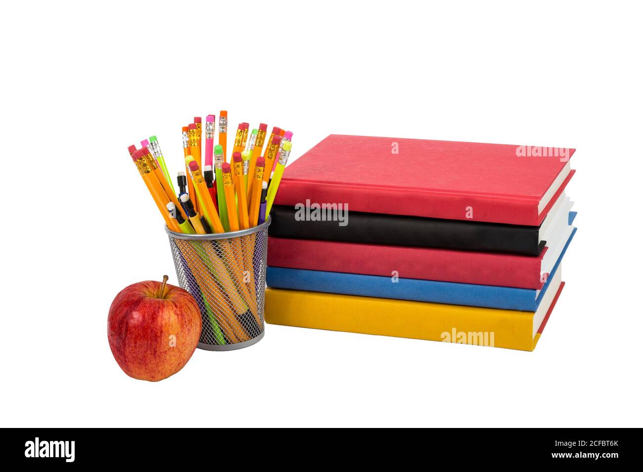 Colorful horizontal photo of a stack of books with an apple and colorful pencils. Isolated on a white background. Stock Photo