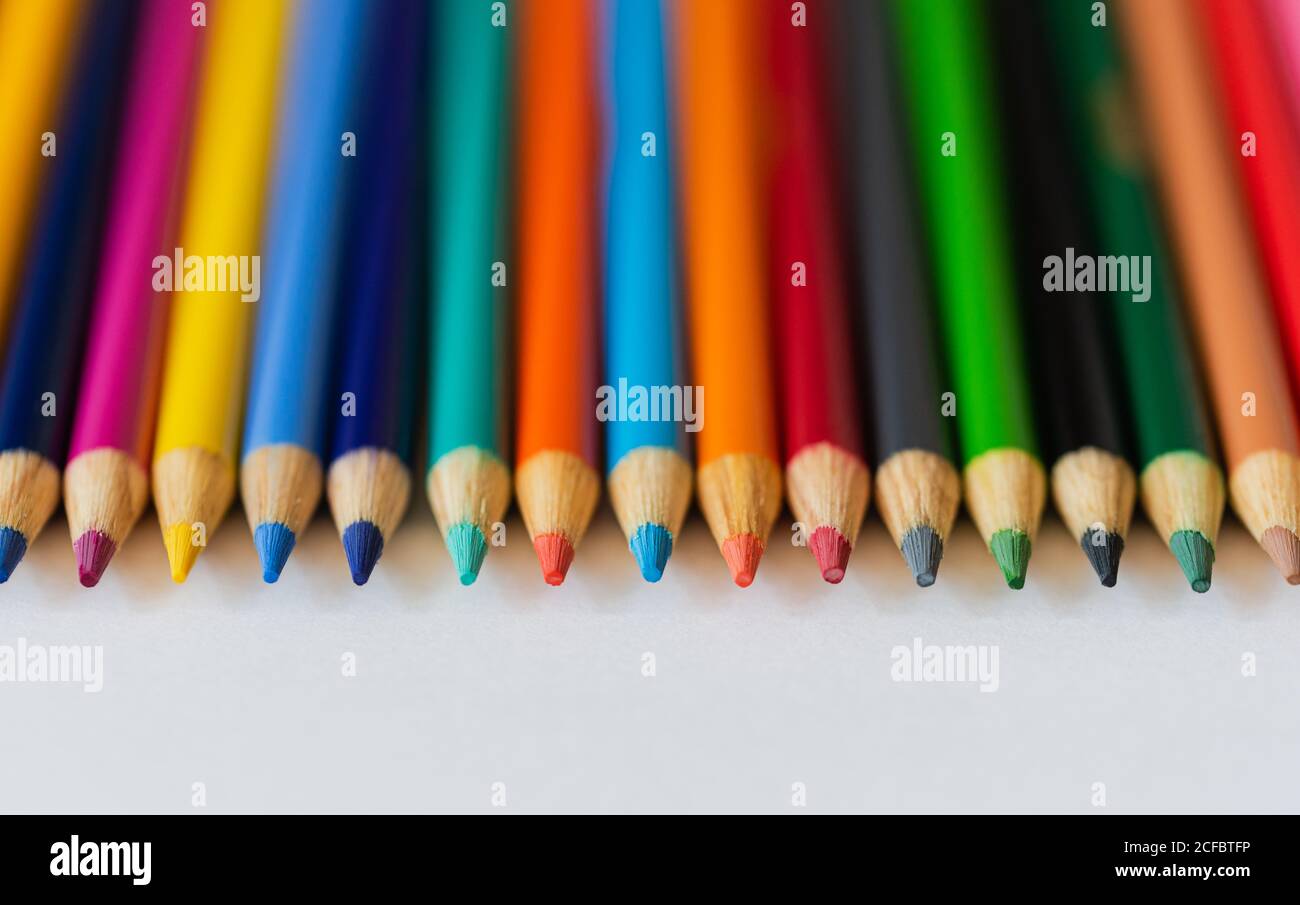 Close up of sharp tips of pencil crayons on white background. Stock Photo