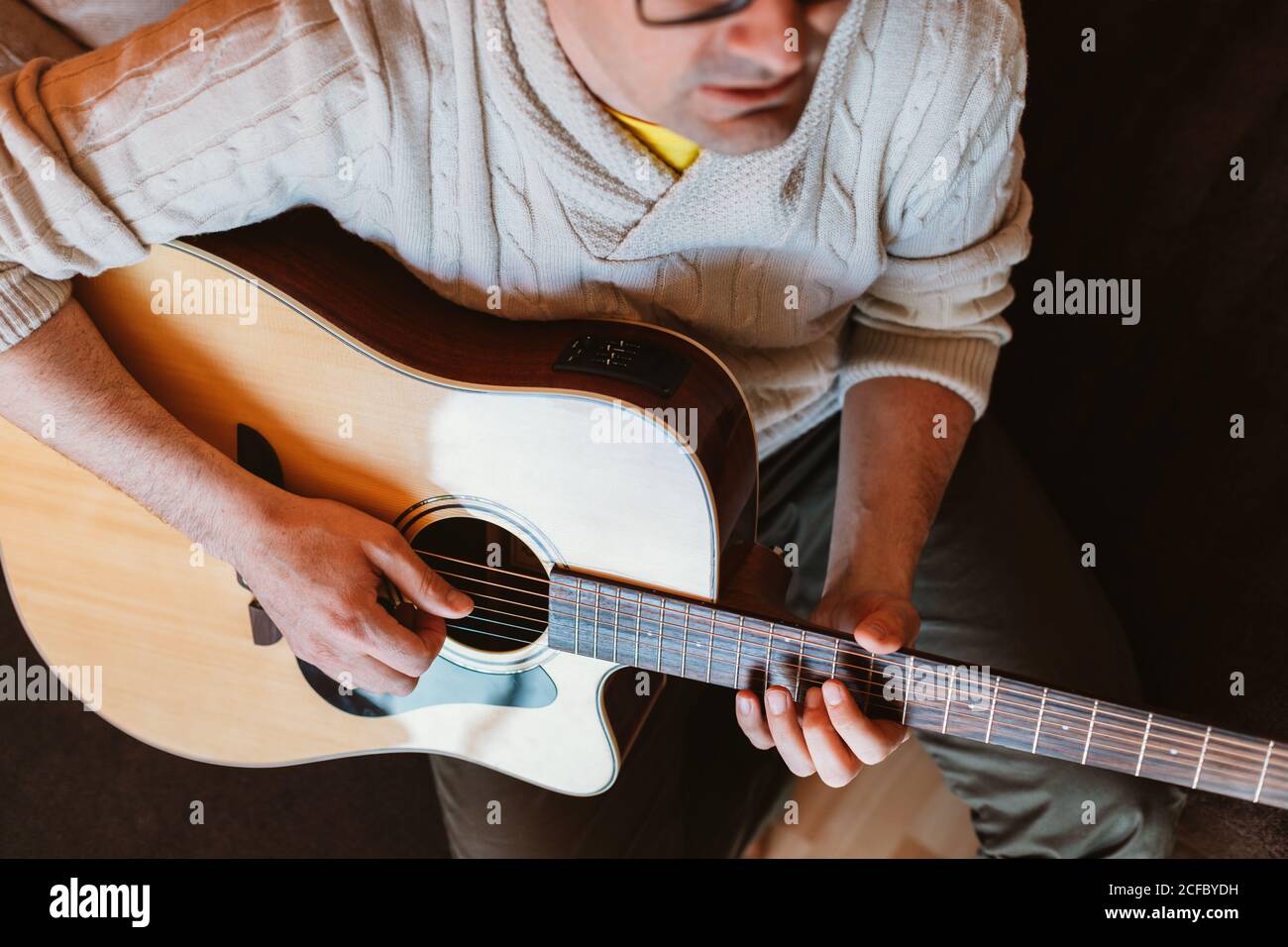 man playing the guitar at home Stock Photo
