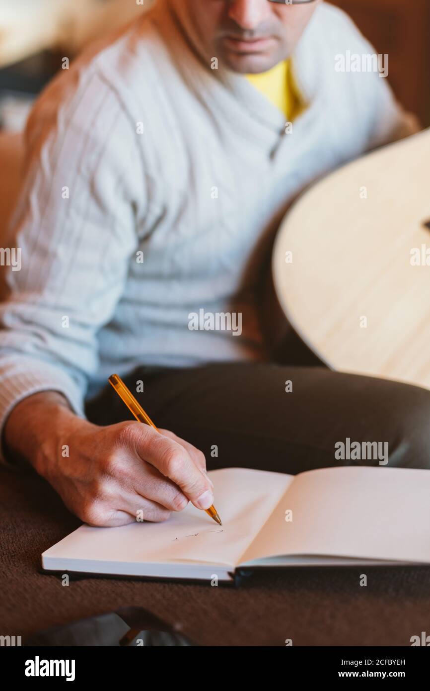 Musician writing in a notebook Stock Photo