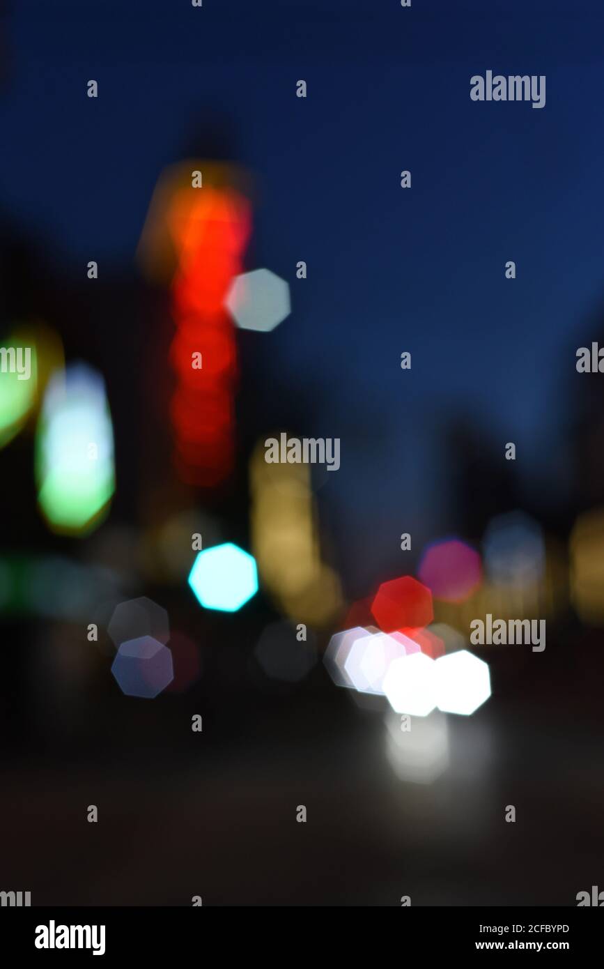 Out of focus building and vehicle lights form an impressionistic urban landscape Stock Photo