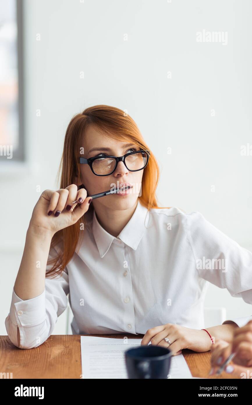 Beautiful business woman thinking while working on computer at office ...