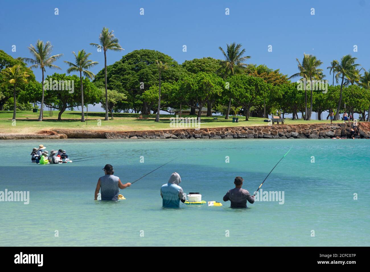 Summer fishing for bigeye scad or halalu, Selar crumenophthalmus, at Ala Moana Beach, Honolulu, Oahu, Hawaii, USA Stock Photo