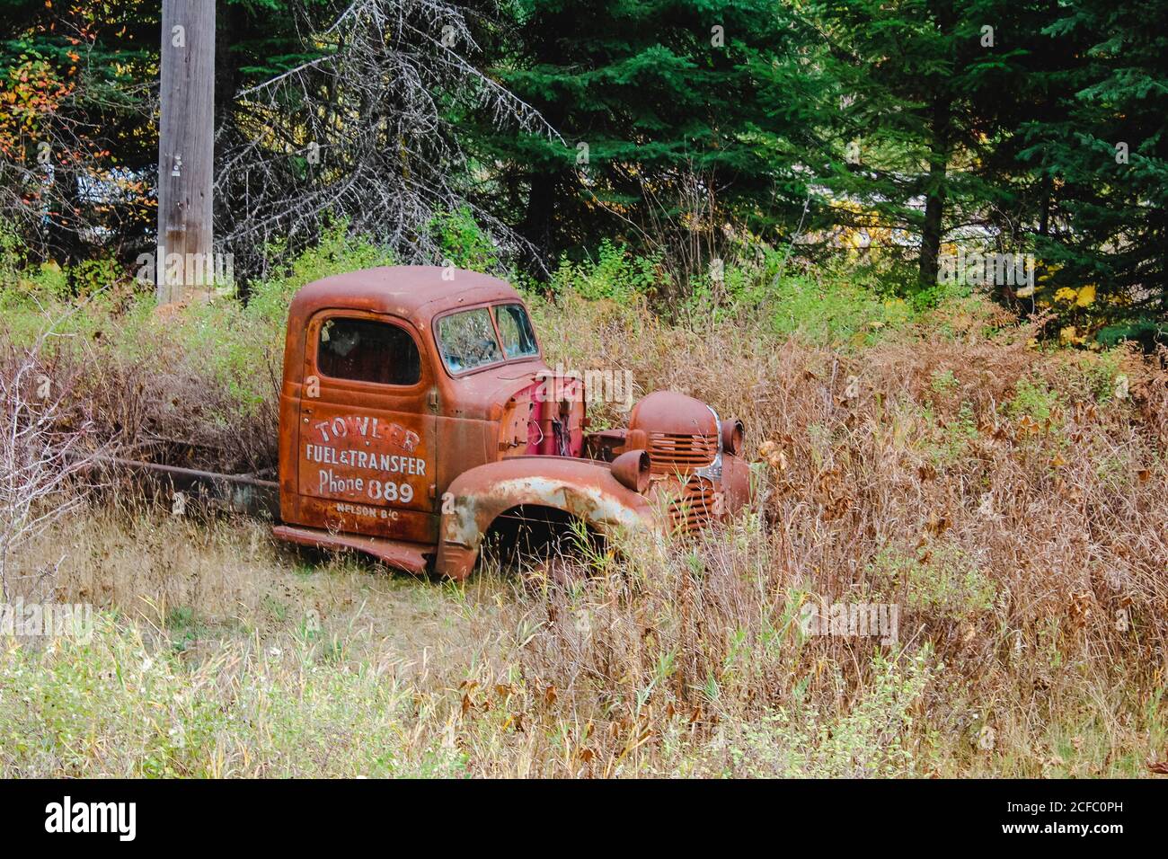 Old cars / vans in Canada by the roadside, wrecks tow trucks Stock Photo