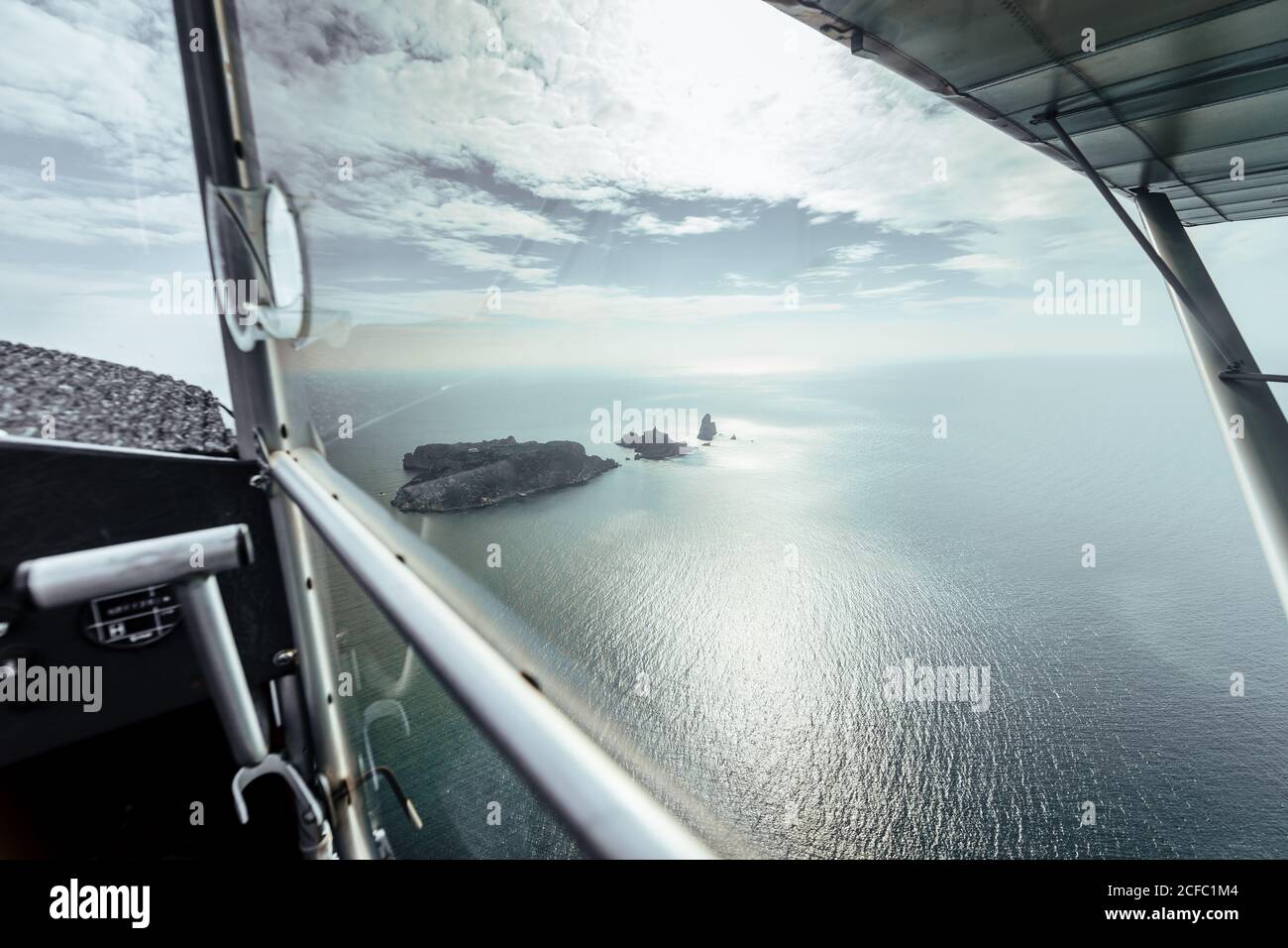 Aerial view on some islands from the inside of a small plane Stock Photo