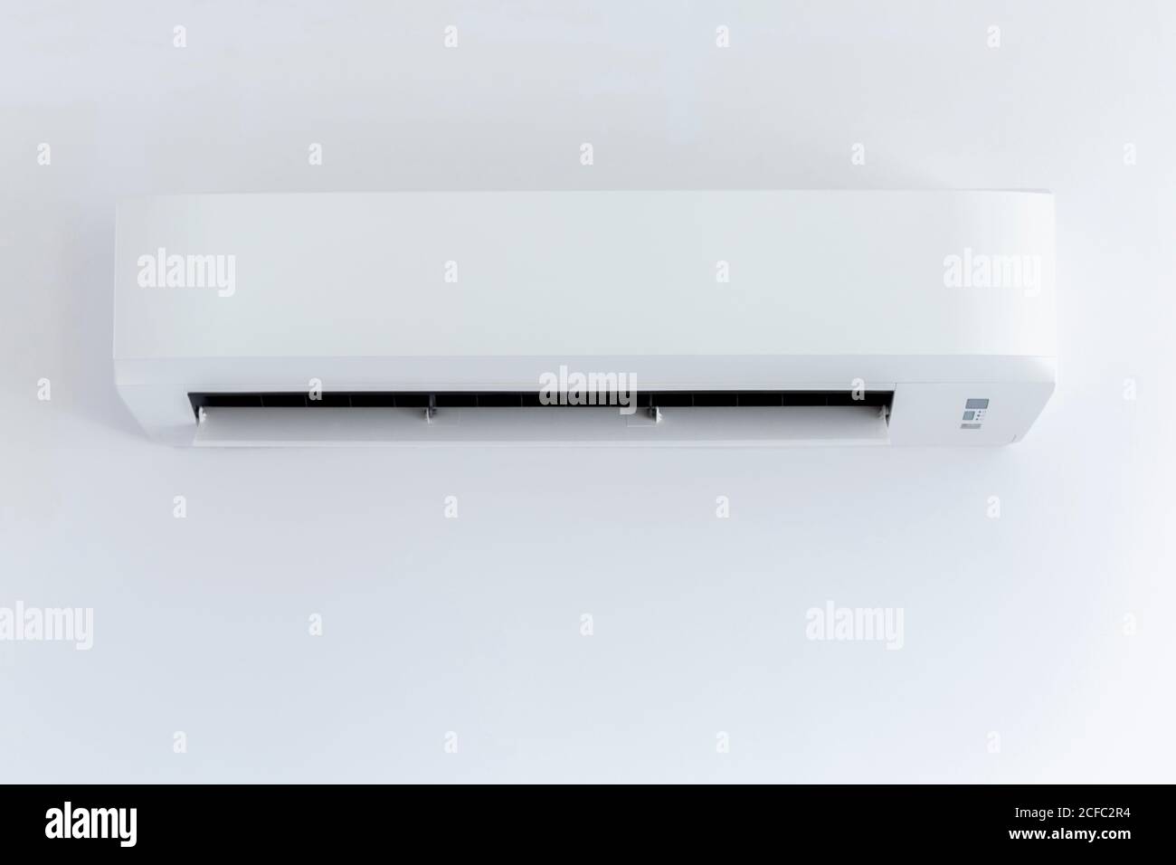 White air conditioner hanging on white wall Stock Photo - Alamy