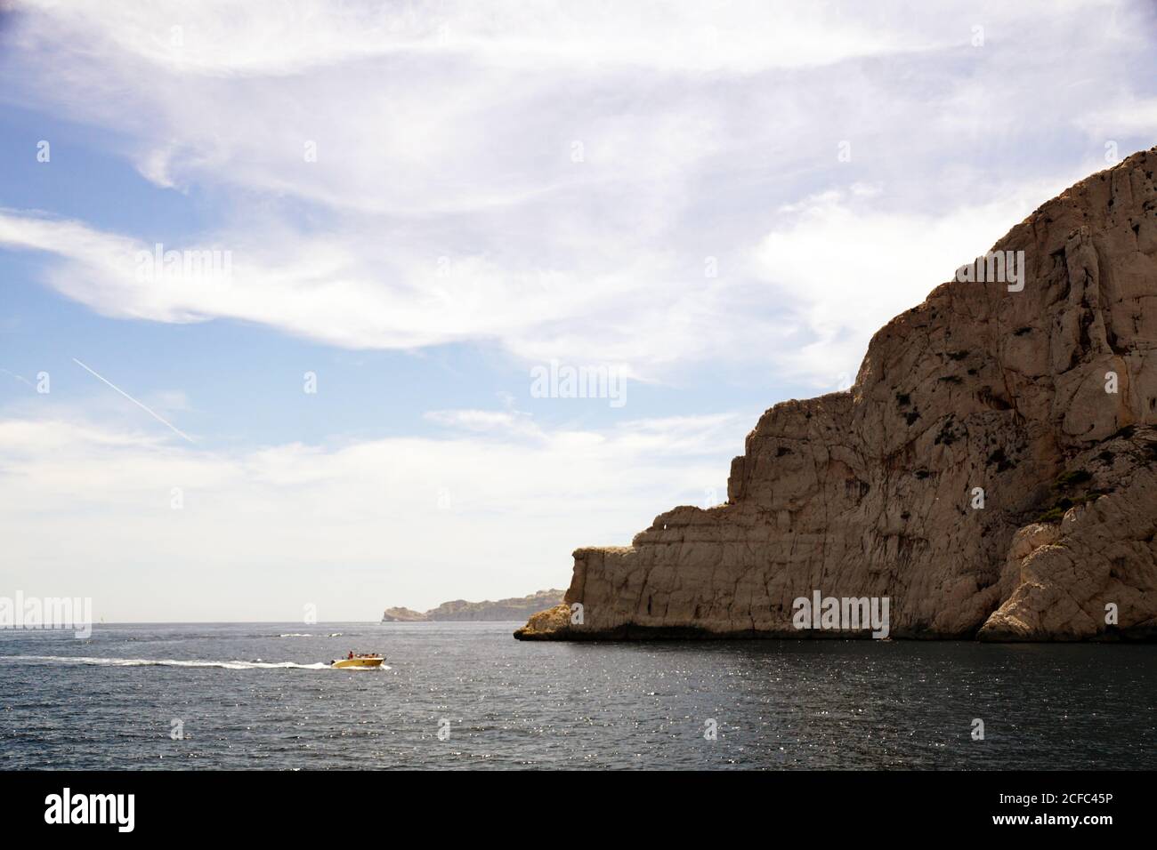 Limestone rocks and boat sailing in sea Stock Photo - Alamy