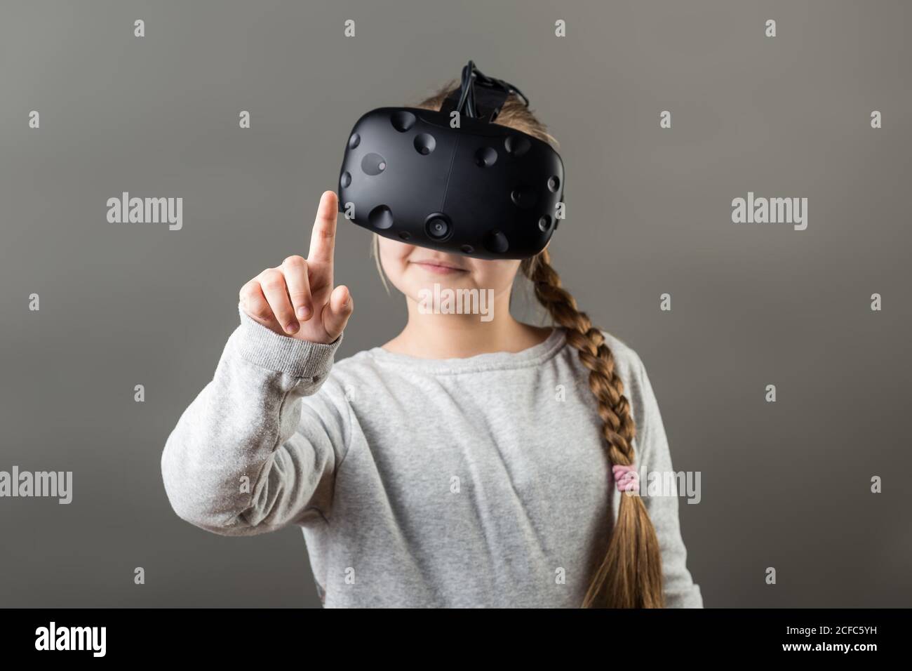 girl wear with with VR device and finger touch in air Stock Photo